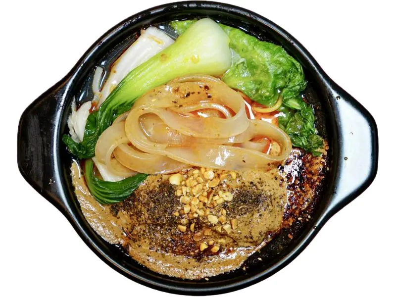 Casserole wide noodles with greens and peanut toppings at Yu Lao Tou Malatang, a Chinese Restaurant in Flushing